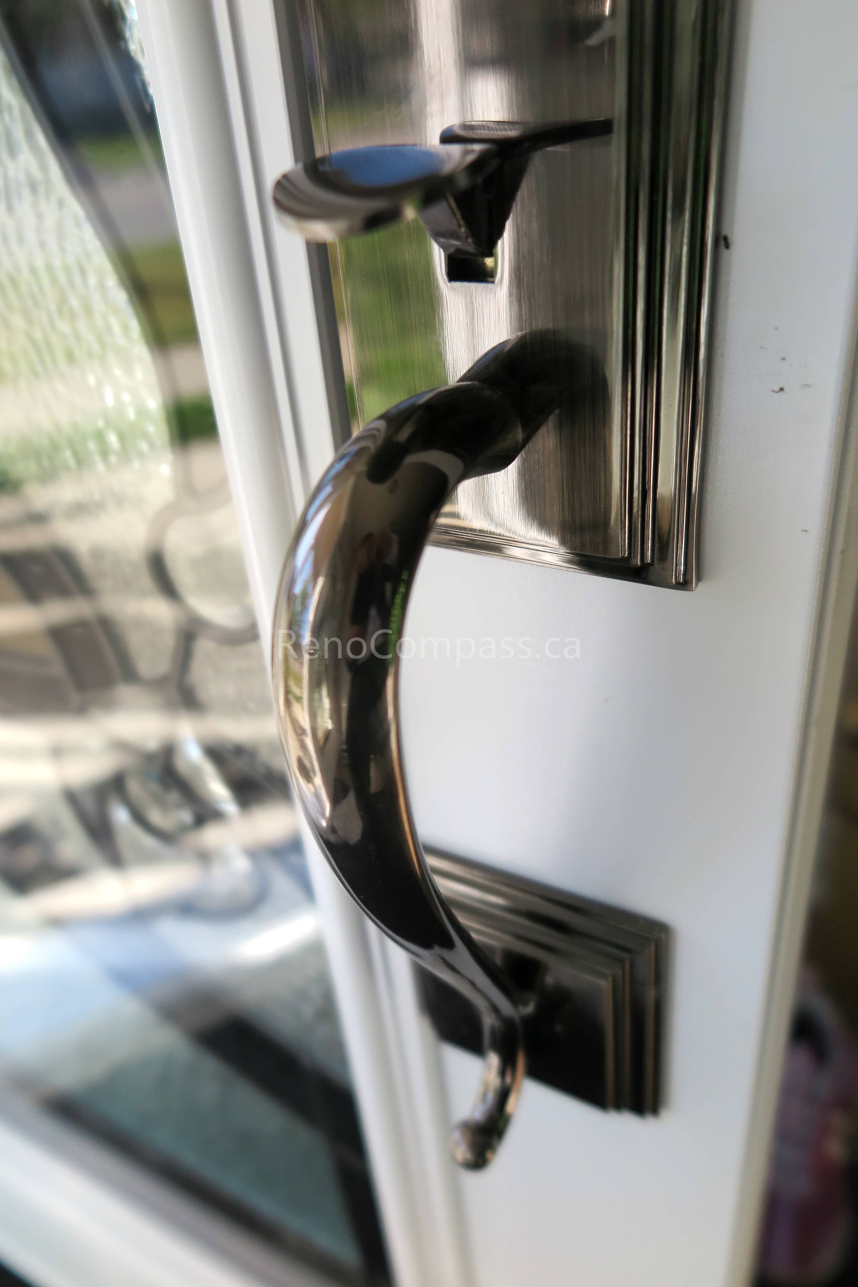 Close-up detail of newly installed double entry door hardware in a New market home, featuring modern black handles and secure locking systems paired with decorative privacy glass panels. Completed by a professional Toronto Renovation Company, this door upgrade enhances both security and visual appeal while adding a refined, high-end finish to the home’s main entrance.