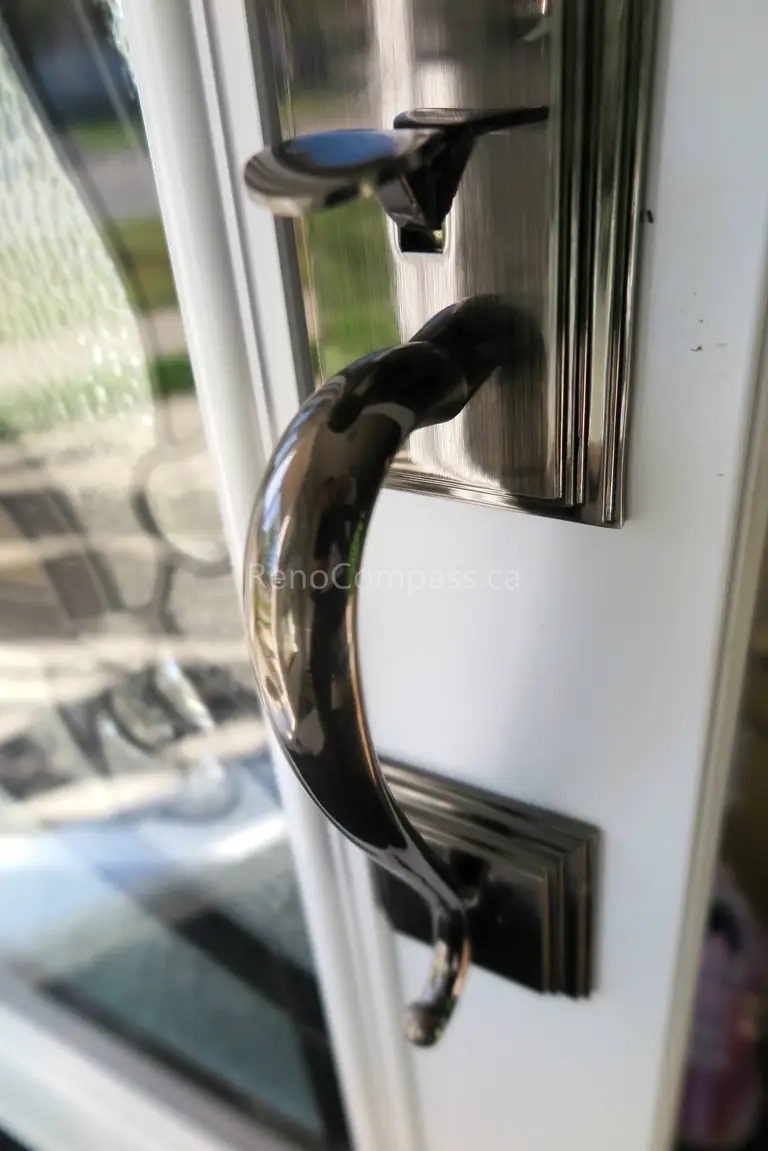 Close-up detail of newly installed double entry door hardware in a New market home, featuring modern black handles and secure locking systems paired with decorative privacy glass panels. Completed by a professional Toronto Renovation Company, this door upgrade enhances both security and visual appeal while adding a refined, high-end finish to the home’s main entrance.