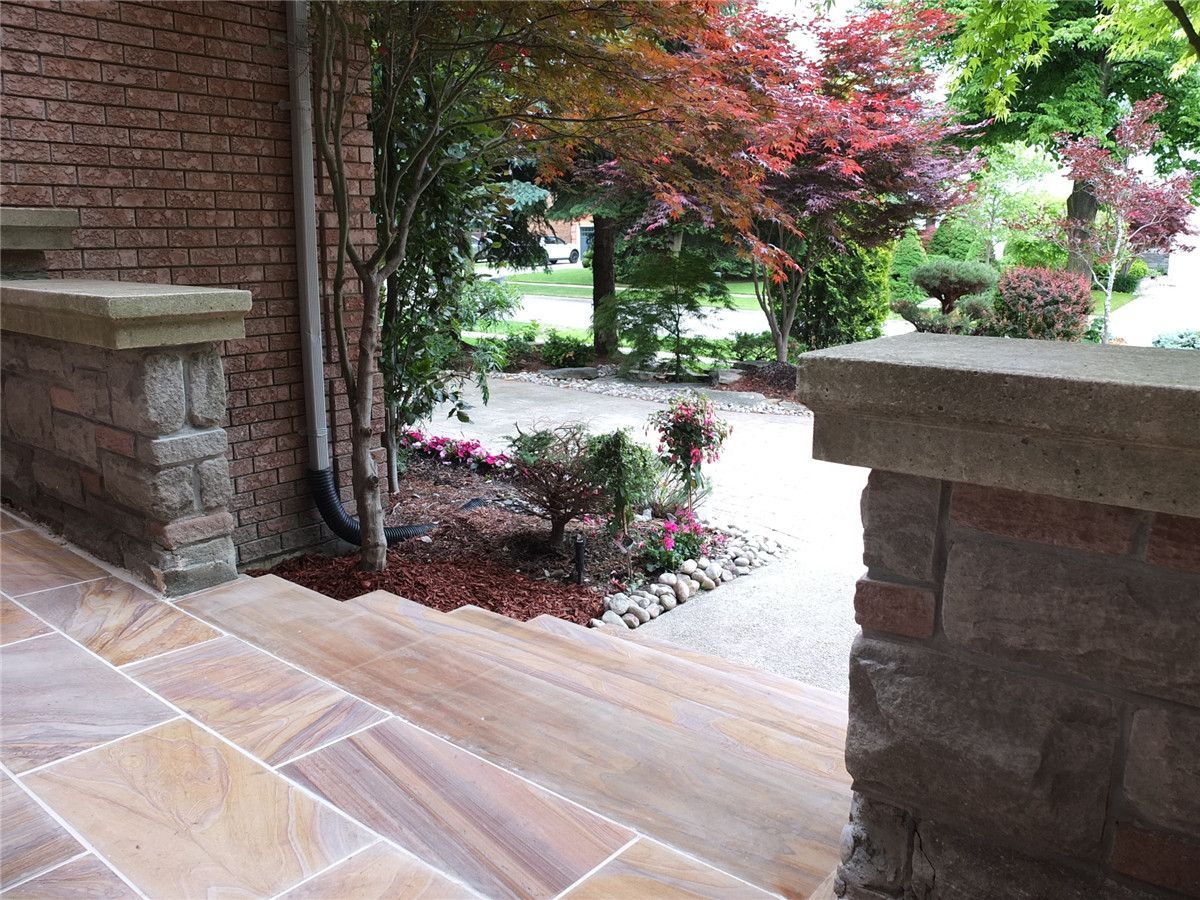 This Richmond Hill front entrance renovation showcases a newly installed interlocking stone porch with durable natural-tone tiles and clean modern finishing. The upgraded entrance landing improves safety, drainage, and curb appeal while complementing the home’s brick exterior and stone pillars. Completed by a trusted Toronto renovation company, this landscaping and interlocking project delivers a refined, long-lasting front entry designed for both functionality and visual impact