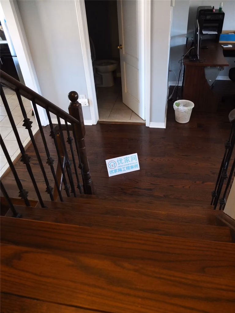 This close-up image showcases the rich natural wood grain of newly installed hardwood flooring in a Mississauga home renovation project. The flooring features deep brown tones, precise plank alignment, and clean baseboard finishes that create a refined and durable interior surface. As a professional Toronto Renovation Company, Reno Compass specializes in high-quality hardwood flooring installation that enhances both aesthetic appeal and long-term value for residential properties.