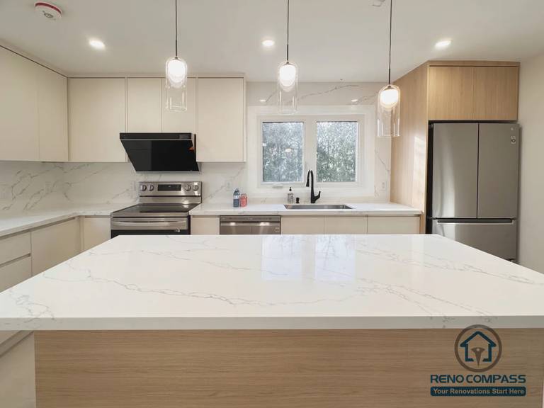 This Oakville interior renovation features a modern open-concept kitchen designed to enhance light, flow, and everyday functionality. The space includes a custom kitchen island with quartz countertops, clean-lined cabinetry, integrated lighting, and thoughtfully selected finishes that create a bright and cohesive atmosphere. The updated layout improves circulation between the kitchen and dining area, offering a practical yet refined setting for daily living and entertaining.