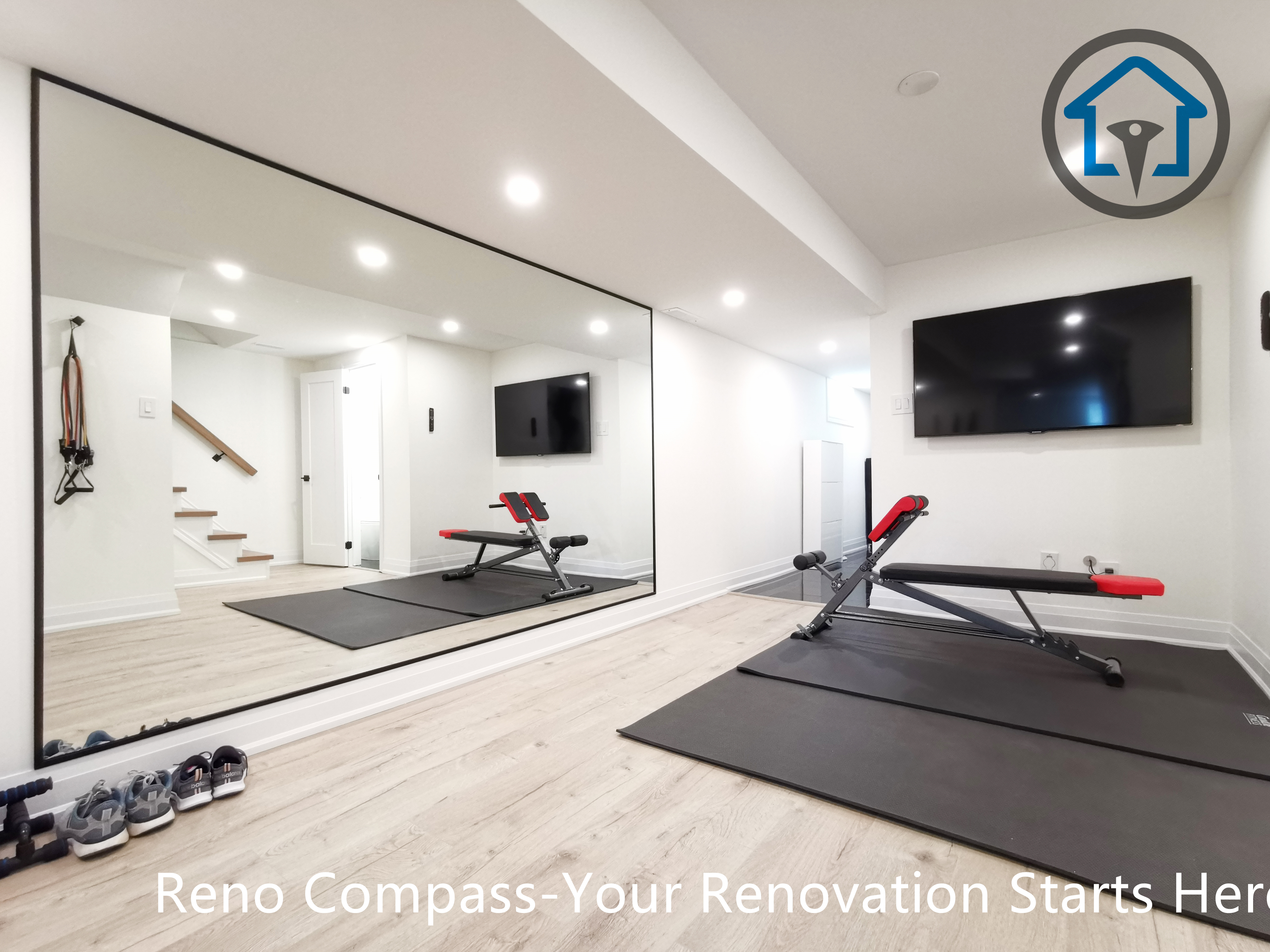 This North York basement renovation transforms the space into a modern home gym featuring a full mirror wall, recessed ceiling lighting, and durable light-tone flooring. The open layout improves brightness and functionality, creating a clean and versatile workout area completed by a Toronto renovation company focused on practical design and high-quality finishing.