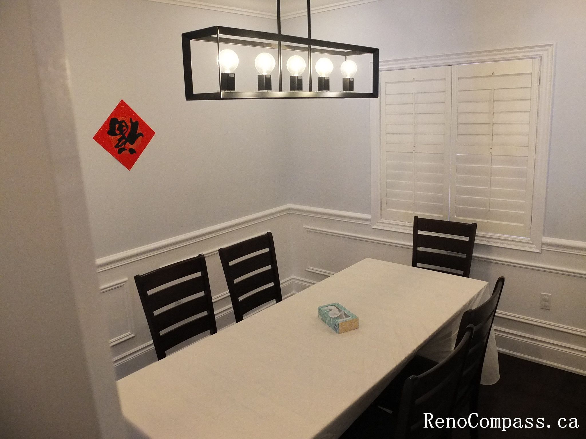 Formal dining room renovation in Newmarket featuring custom wall panel molding, recessed pot lights, modern pendant lighting, hardwood flooring, and a clean symmetrical layout. Completed by a trusted Toronto Renovation Company, this interior upgrade enhances elegance and everyday functionality.