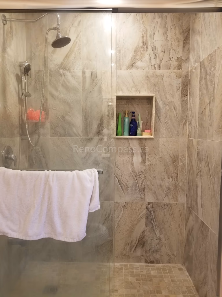 This Markham bathroom renovation features newly installed shower wall tiles with a built-in recessed niche for convenient storage. The modern tile design enhances both functionality and visual appeal, providing a clean, elegant finish that is easy to maintain. As part of a full bathroom upgrade including new flooring, shower, and vanity, the space now offers improved comfort, durability, and a contemporary look for everyday use.