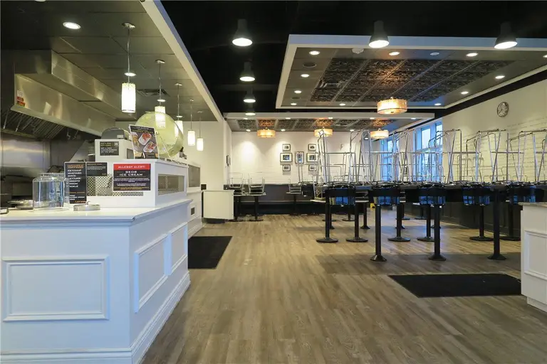 This Toronto commercial restaurant renovation showcases the fully completed dining area and open-concept service layout by Reno Compass Inc. The project focused on maximizing operational flow while creating a welcoming customer environment.

Key upgrades included custom front counters, integrated commercial kitchen access, modern suspended ceiling features with recessed and pendant lighting, and durable wood-look vinyl flooring designed for high-traffic restaurant use. The spacious dining area layout ensures smooth circulation between service stations and seating zones.

By combining functionality with clean architectural lines, this project reflects Reno Compass Inc.’s expertise in delivering professional restaurant renovations across Toronto, built to meet commercial standards and long-term business performance.