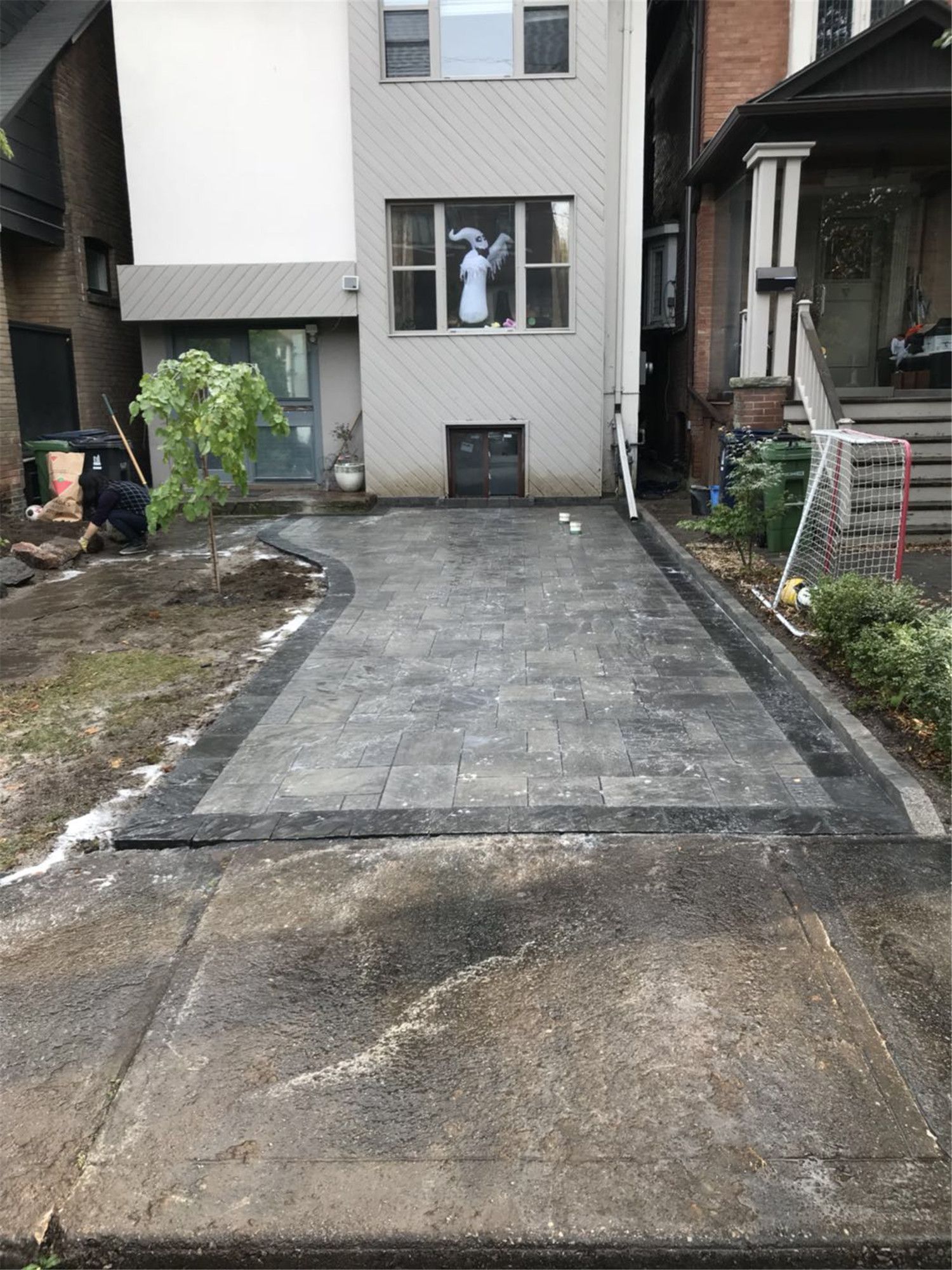 Toronto landscaping renovation featuring a newly installed interlock driveway with clean borders and durable paving stones. This project improves driveway durability, drainage, and curb appeal while providing a modern and low-maintenance entrance for a Toronto residential property.