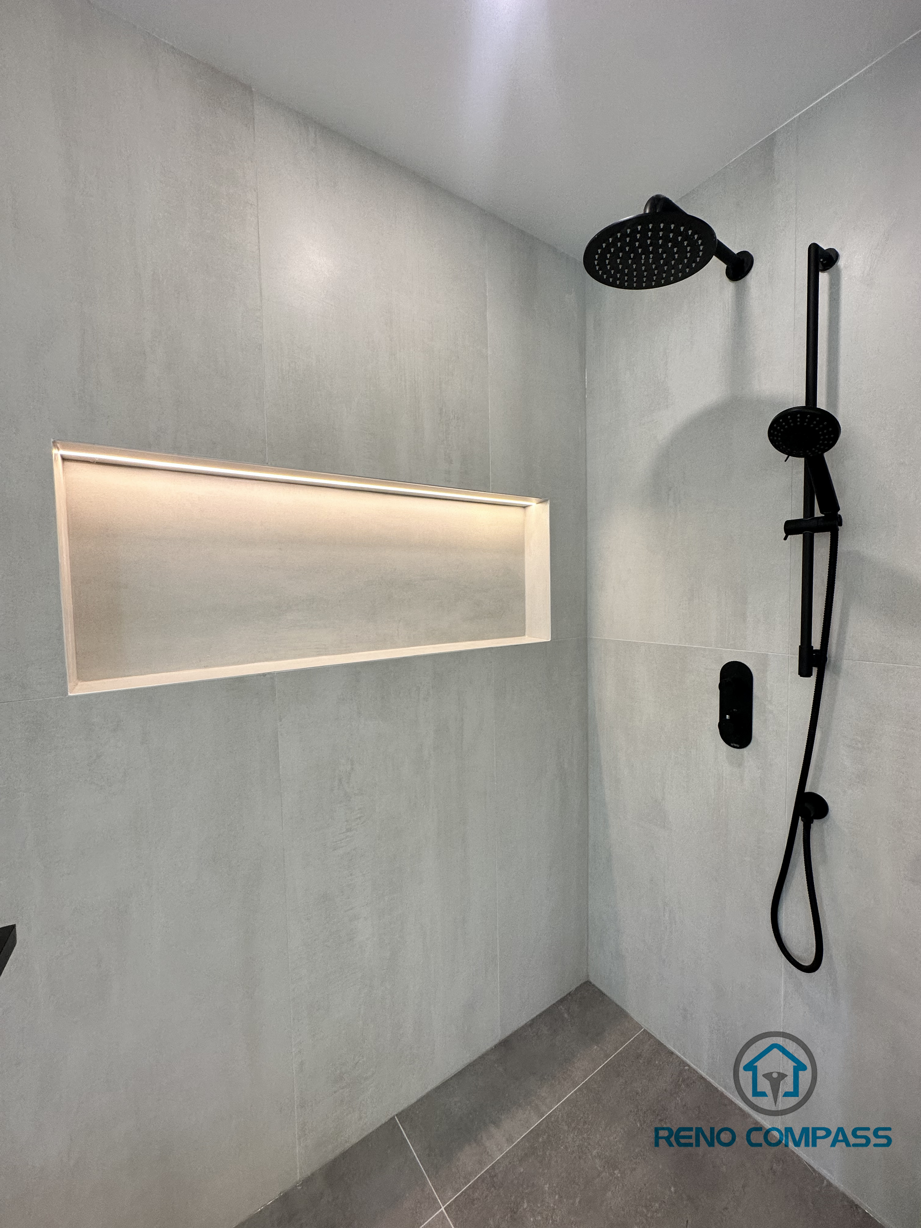 This custom walk-in shower in an Oakville home includes a frameless glass enclosure, built-in niche storage, and integrated LED strip lighting for both functionality and ambiance. Perfect for modern, low-maintenance bathroom upgrades.