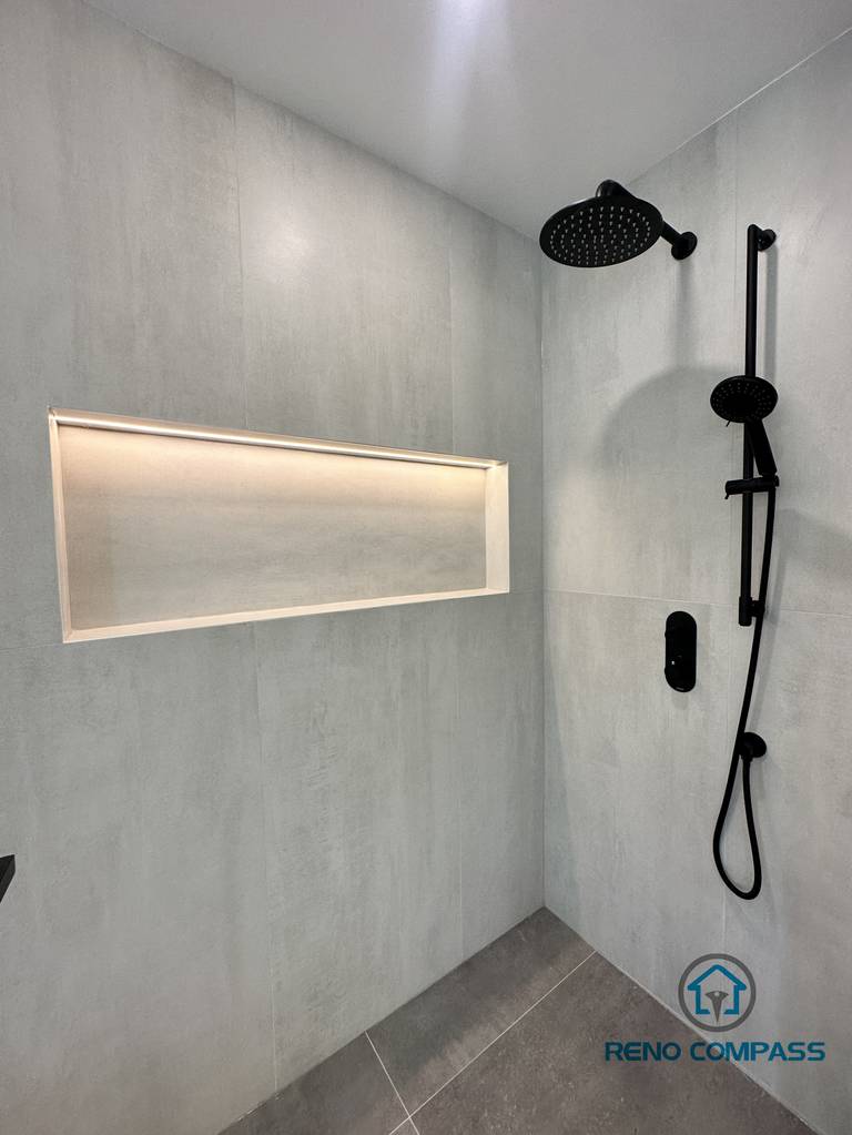 This custom walk-in shower in an Oakville home includes a frameless glass enclosure, built-in niche storage, and integrated LED strip lighting for both functionality and ambiance. Perfect for modern, low-maintenance bathroom upgrades.