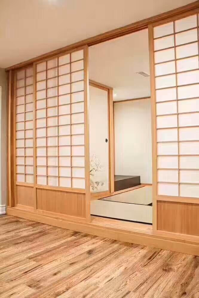 This Markham interior renovation features a custom Japanese-style tatami room designed for relaxation and cultural living. The space includes traditional shoji sliding doors, natural wood framing, and a raised tatami platform that creates a serene and minimalist atmosphere. Warm wood flooring and soft neutral tones enhance the calming aesthetic while maintaining modern functionality. This unique room addition blends traditional Japanese design with contemporary home renovation standards, completed by a professional Toronto renovation contractor specializing in custom interior spaces.