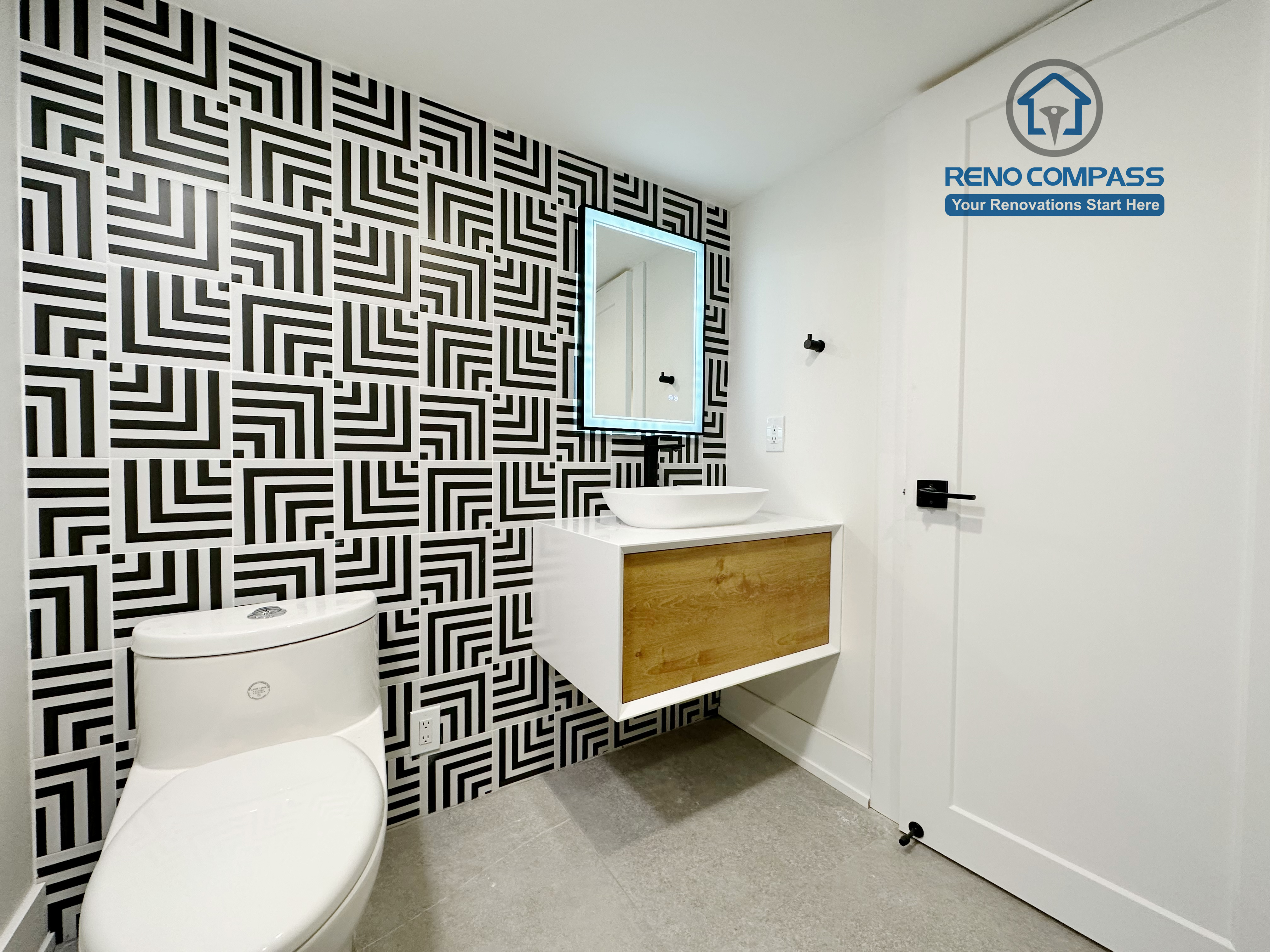 Contemporary bathroom renovation in Richmond Hill featuring a floating wood-accent vanity, modern vessel sink, matte black fixtures, and vertical tile backsplash for a clean and stylish bathroom design.