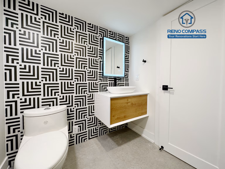 Contemporary bathroom renovation in Richmond Hill featuring a floating wood-accent vanity, modern vessel sink, matte black fixtures, and vertical tile backsplash for a clean and stylish bathroom design.