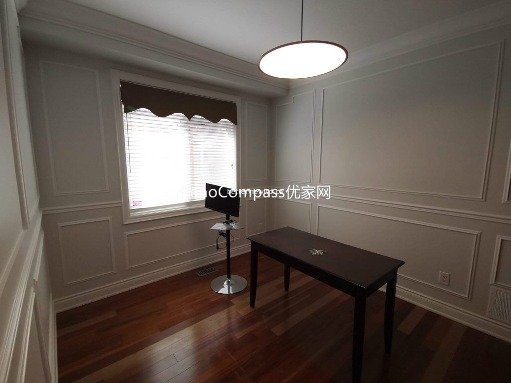 This Richmond Hill home office renovation features elegant wall panel detailing, hardwood flooring, and modern ceiling lighting to create a clean and functional workspace. The refined finishes and bright layout enhance productivity and comfort, showcasing the craftsmanship of a trusted Toronto renovation company specializing in full house interior renovations.