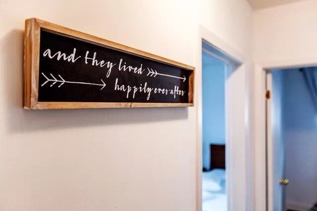 This Toronto interior renovation highlights a simple yet charming hallway décor detail featuring a framed wall sign and clean neutral walls. The bright hallway connects living spaces and bedrooms, creating a warm and welcoming transition area within the home. Thoughtful decorative touches enhance the overall interior renovation and reflect a cozy, modern Toronto home atmosphere.