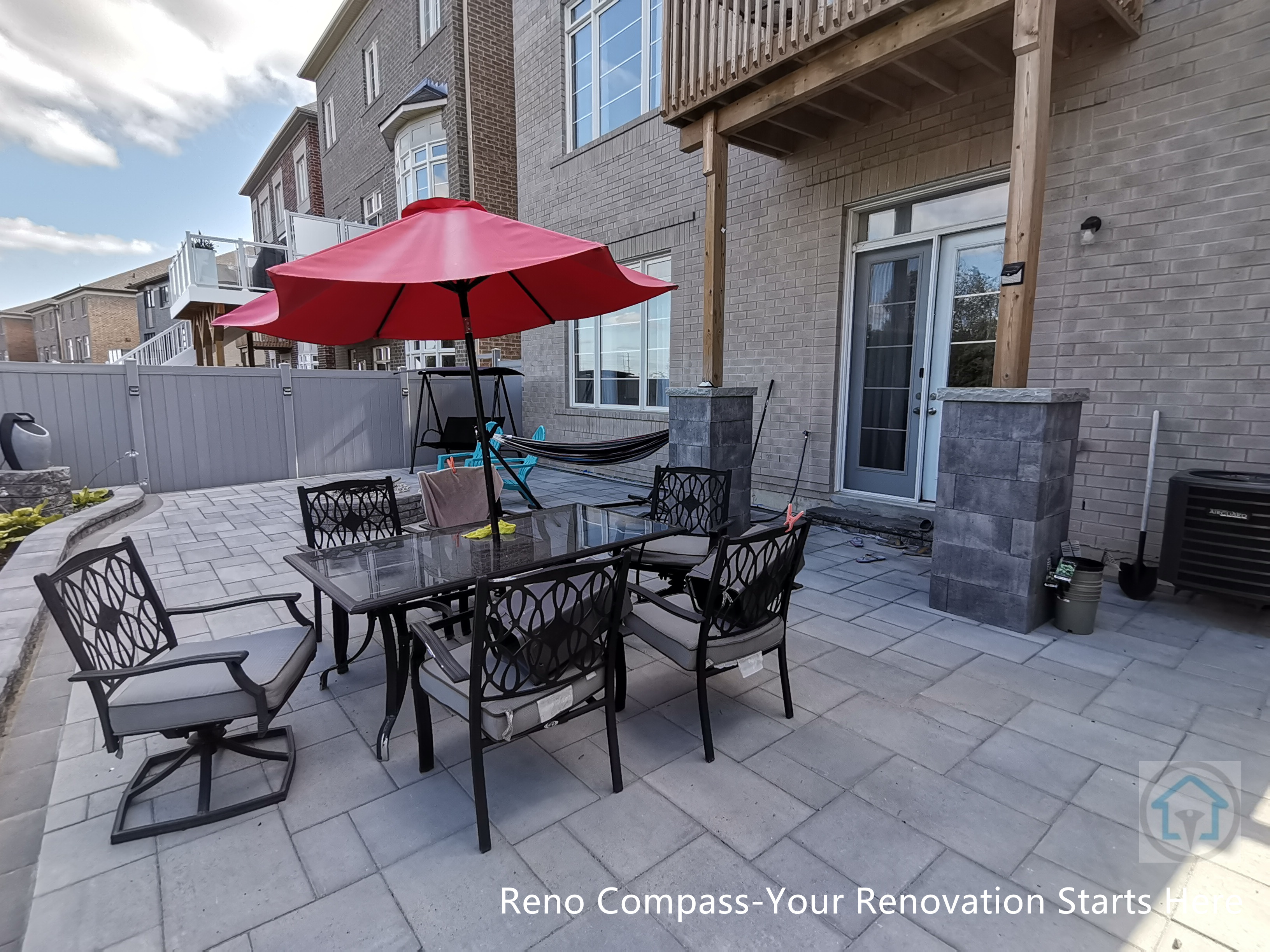This Vaughan backyard interlocking patio features a spacious stone paver layout designed for outdoor dining and relaxation. The clean paving pattern supports patio furniture and daily use, while the open layout connects seamlessly with the deck structure and fencing, creating a comfortable and functional outdoor living space.