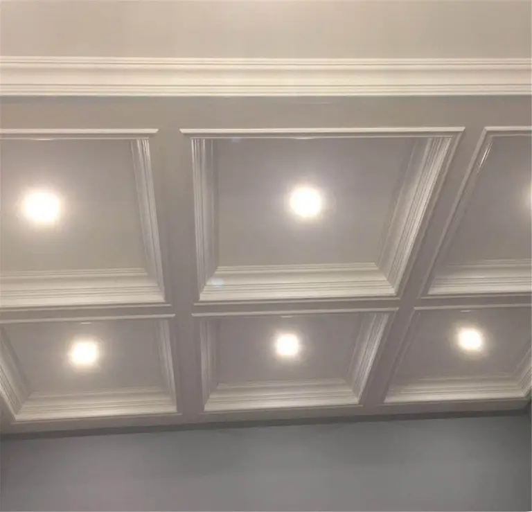 Detailed coffered ceiling design with integrated recessed lighting as part of a Toronto interior renovation. The symmetrical ceiling panels and refined trim work enhance the room’s architectural depth while providing balanced ambient lighting, completed by a professional Toronto renovation company.