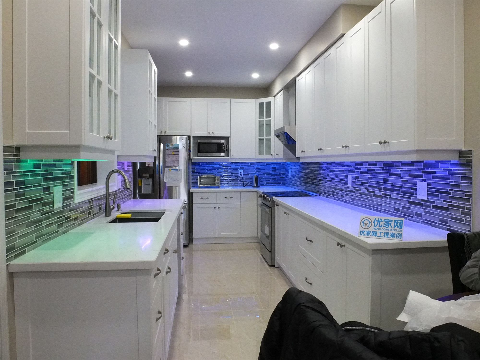 Close-up view of the sink area in this Vaughan kitchen renovation, featuring a modern undermount sink, quartz countertop, and sleek glass mosaic backsplash. The upgraded faucet and clean countertop design enhance both functionality and visual appeal. Completed by a professional Toronto renovation company, this detail highlights the craftsmanship and modern finishing of the kitchen upgrade.