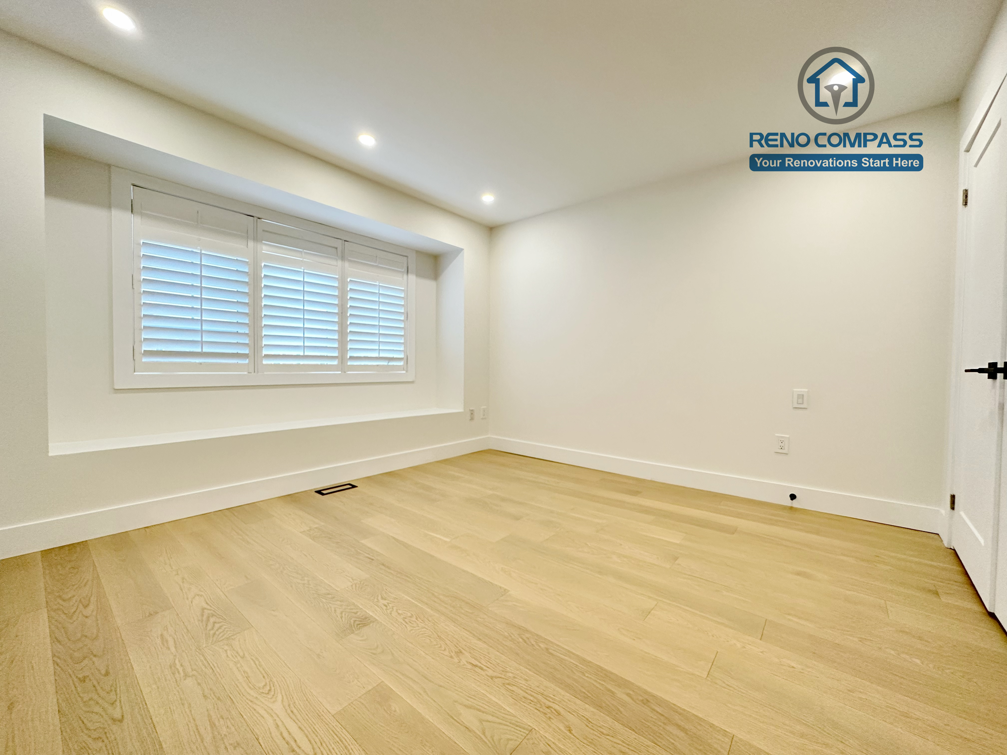 Bright bedroom renovation in a Richmond Hill home featuring light-tone hardwood flooring, a large window with custom trim, recessed ceiling lighting, and a clean, modern interior layout.
