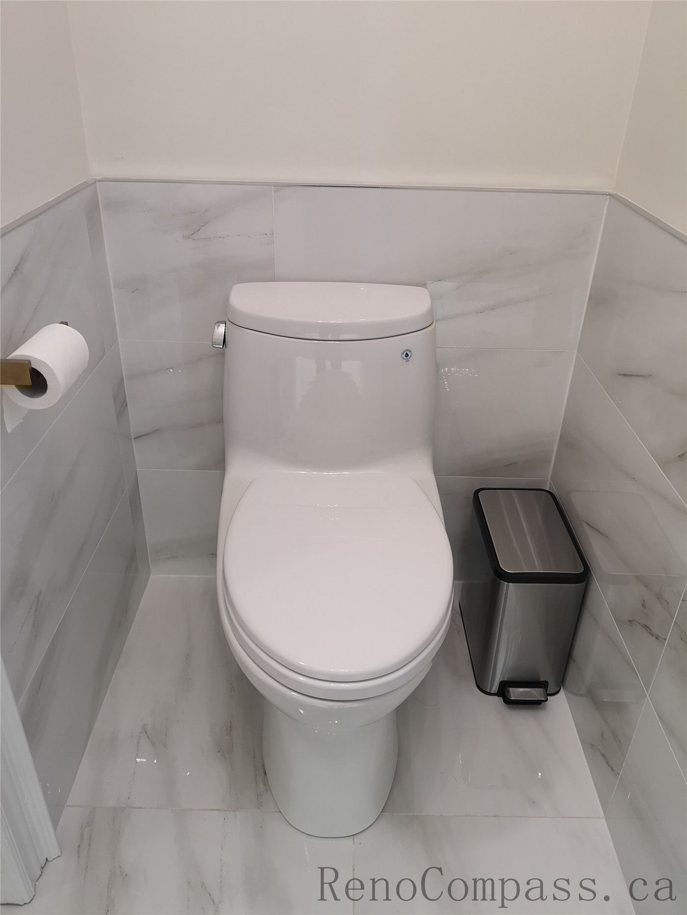 This Aurora bathroom renovation features a clean and modern toilet installation with marble-style wall and floor tiles for a bright, elegant finish. The space is designed for durability, easy maintenance, and a timeless aesthetic, combining functional layout with refined details. Completed by a professional Toronto renovation company focused on quality workmanship and contemporary interior upgrades.