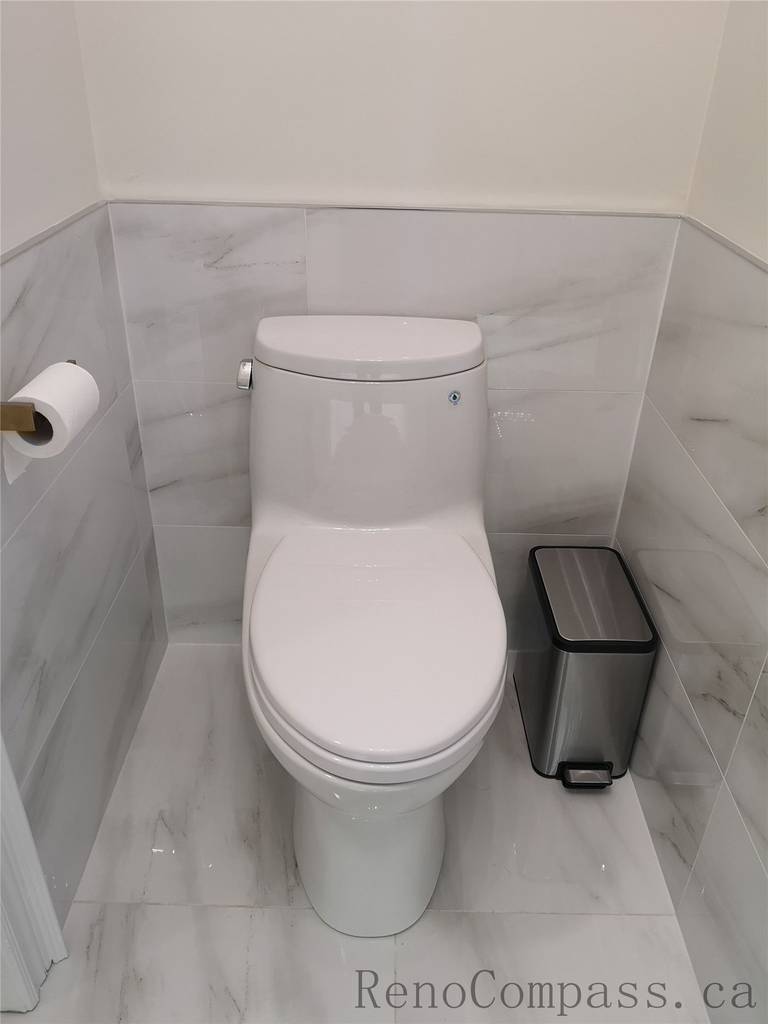 This Aurora bathroom renovation features a clean and modern toilet installation with marble-style wall and floor tiles for a bright, elegant finish. The space is designed for durability, easy maintenance, and a timeless aesthetic, combining functional layout with refined details. Completed by a professional Toronto renovation company focused on quality workmanship and contemporary interior upgrades.
