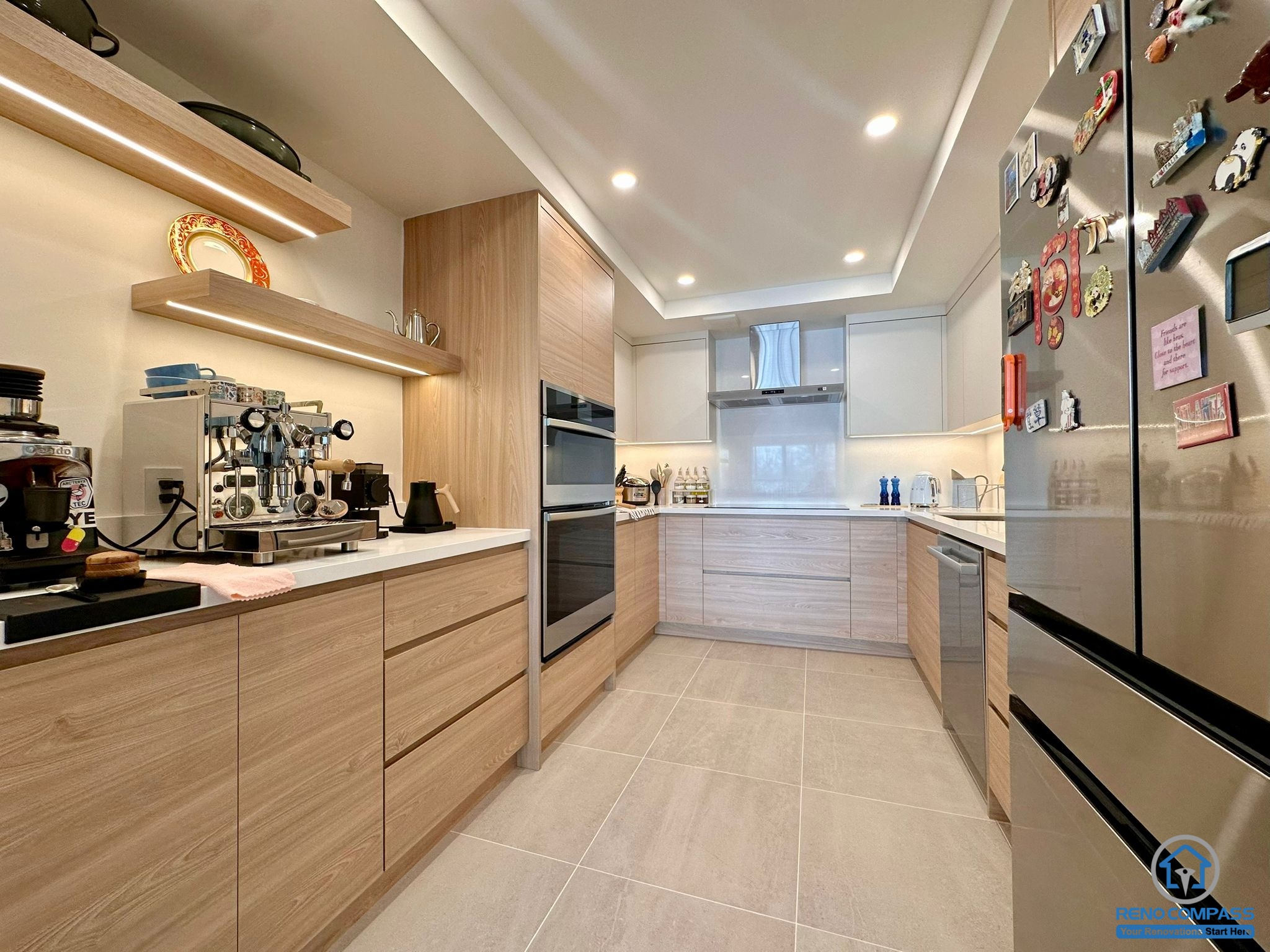 A fully renovated modern kitchen in Toronto featuring custom wood cabinetry, integrated appliances, recessed lighting, and a clean contemporary layout. The new design maximizes storage, workflow, and modern aesthetics for everyday living.