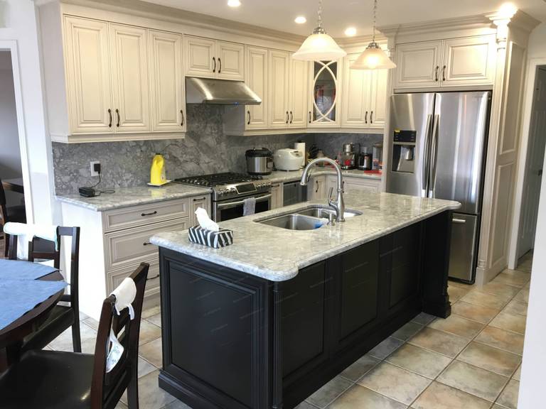 This Oakville interior renovation features a beautifully upgraded kitchen with custom cabinetry, marble-style countertops, and a spacious central island. The design blends classic elegance with modern functionality, including stainless steel appliances, upgraded lighting, and a practical layout that enhances daily living and entertaining. Completed by a professional renovation team, this project showcases high-quality craftsmanship and timeless interior design for Oakville homeowners.