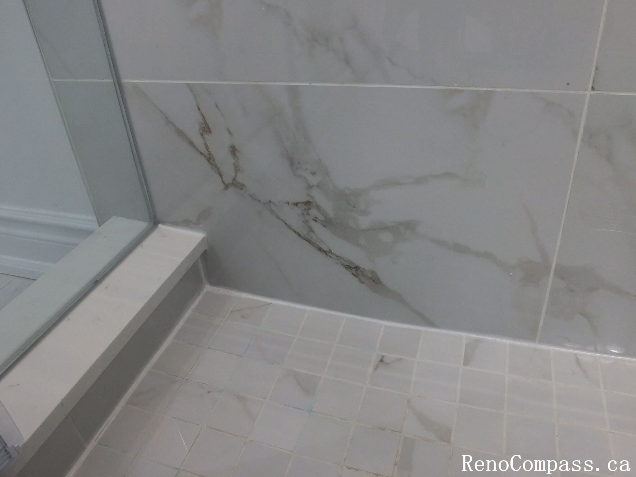 This Richmond Hill bathroom renovation highlights premium marble-look wall tiles and slip-resistant shower flooring for a clean and modern finish. Completed by a professional Toronto renovation company, the detailed tile installation enhances durability, water resistance, and visual elegance. The seamless glass shower base and neutral tones create a refined, spa-like atmosphere while ensuring long-term performance and easy maintenance.