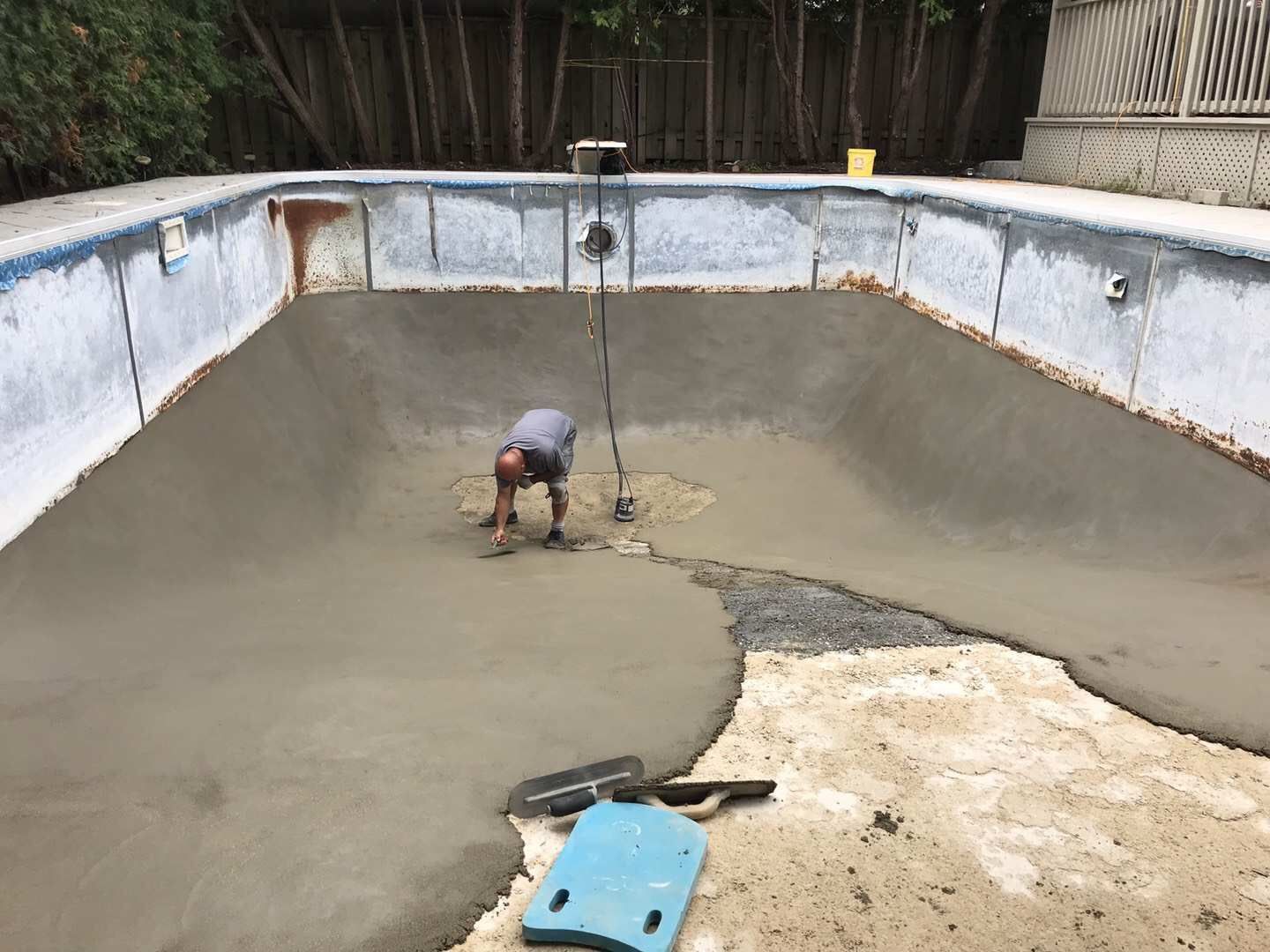 Professional swimming pool restoration in Toronto featuring concrete base repair and resurfacing work. This stage highlights structural repair, leveling, and new concrete application to strengthen the pool foundation and prepare for final finishing, ensuring long-term durability and performance for a residential pool renovation project.