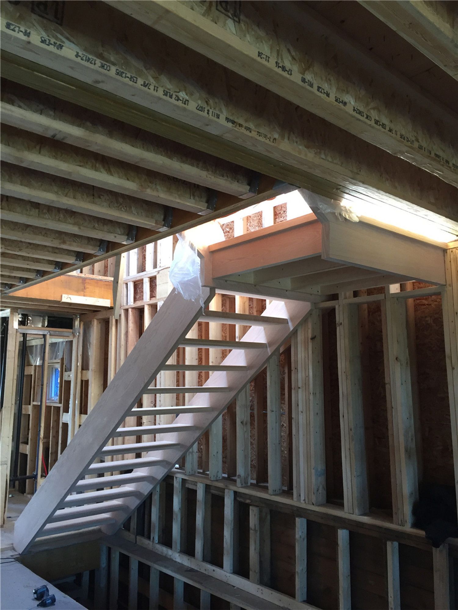This image shows a newly installed hardwood staircase during a basement renovation project in Toronto. The staircase structure is carefully built with evenly spaced treads and strong side framing to ensure safety, durability, and proper access between levels. Installed within a framed construction environment, this stair system demonstrates precise carpentry and structural planning. As a professional Toronto Renovation Company, Reno Compass Inc. provides high-quality staircase installation and renovation services for residential projects across Toronto and the Greater Toronto Area.