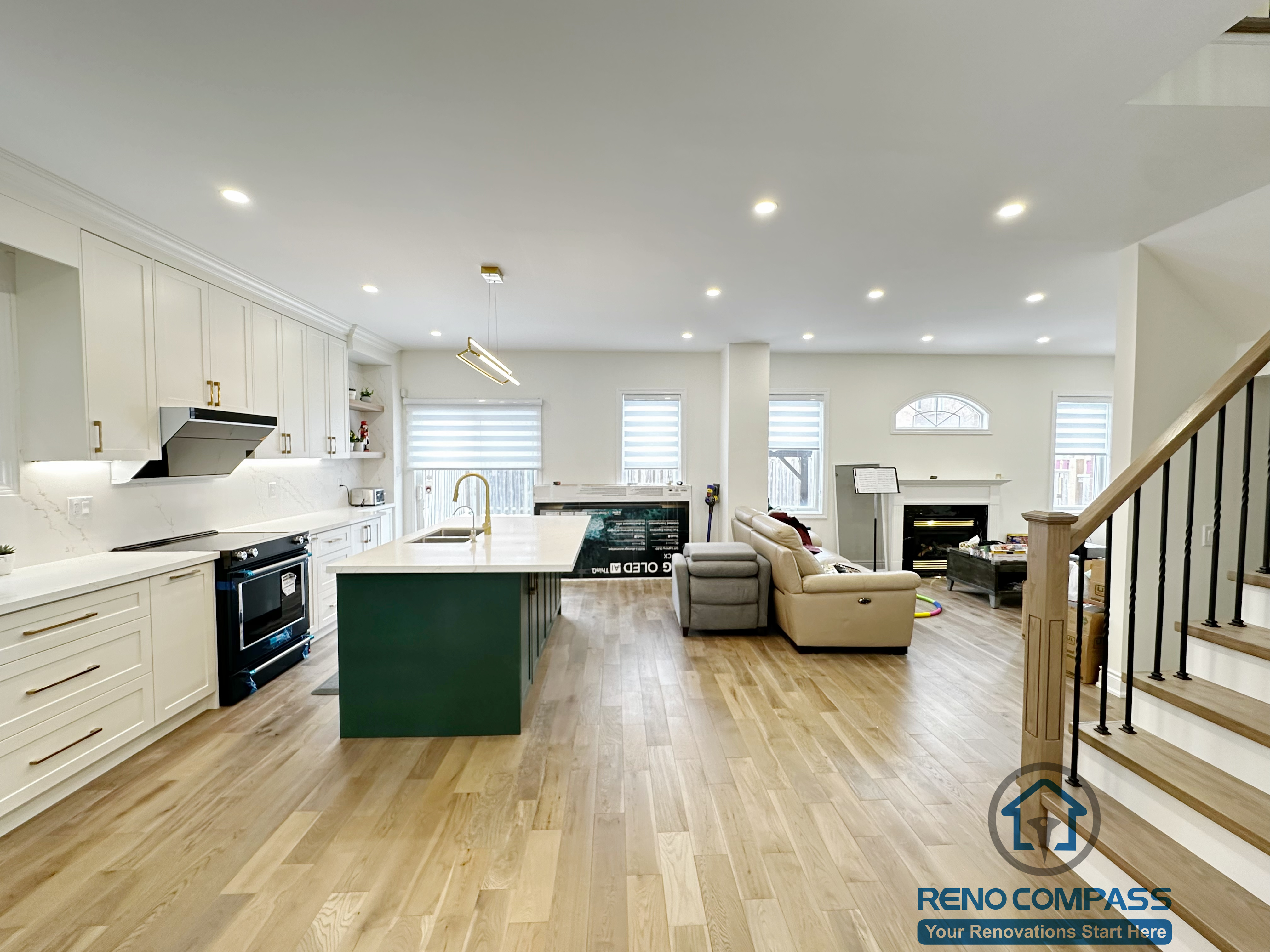 Main-floor interior renovation in Markham featuring an open-concept layout that connects the kitchen, dining, and living areas. Consistent flooring, recessed lighting, and a central kitchen island create a balanced and functional family-oriented space.