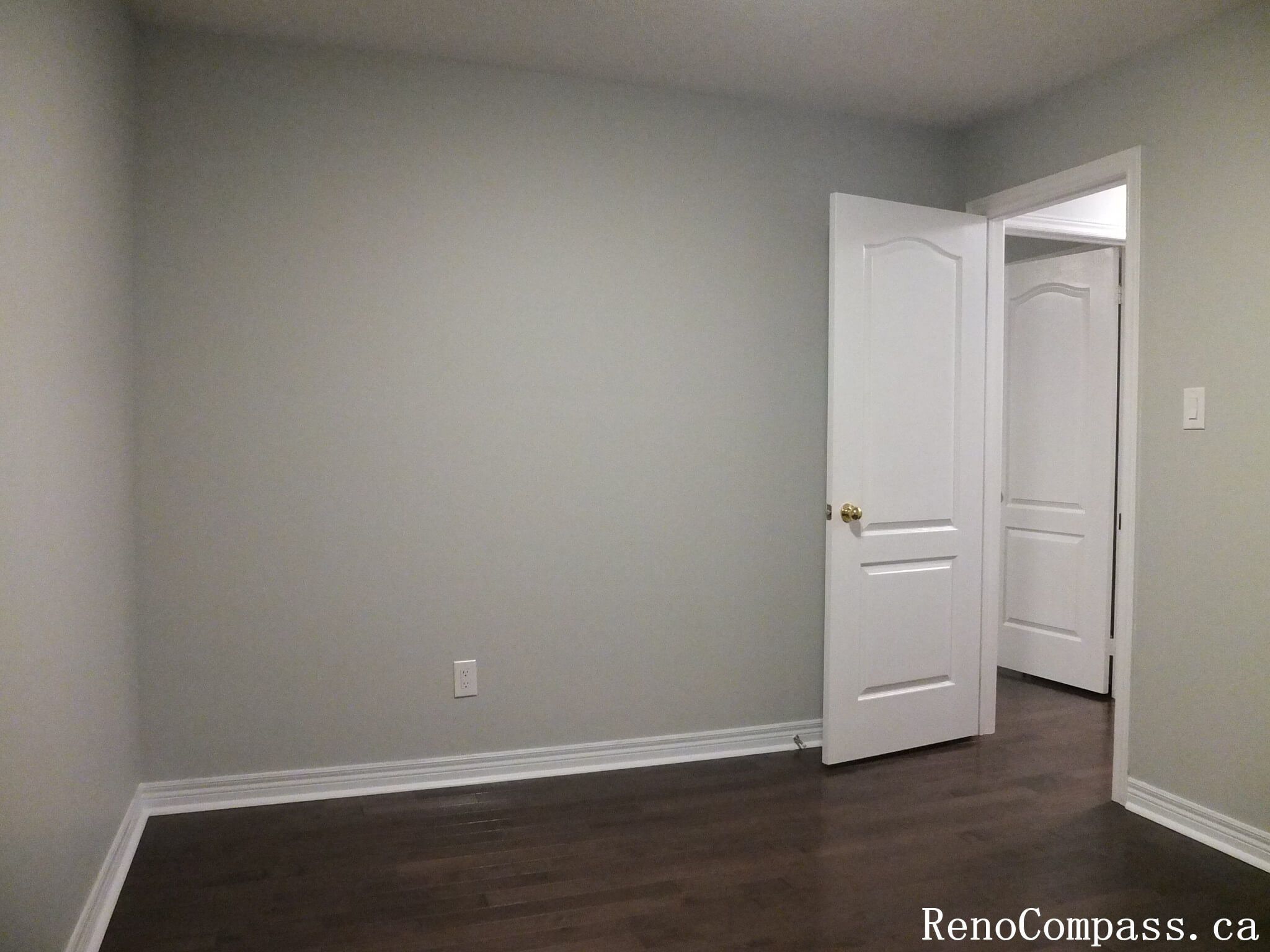 This Richmond Hill interior renovation showcases a refreshed bedroom with rich hardwood flooring, smooth neutral wall finishes, and updated trim details. Completed by a professional Toronto renovation company, the space is designed to feel bright, clean, and versatile for modern living. The refined finishes and cohesive color palette create a comfortable and timeless room suitable for everyday use or guest accommodation.