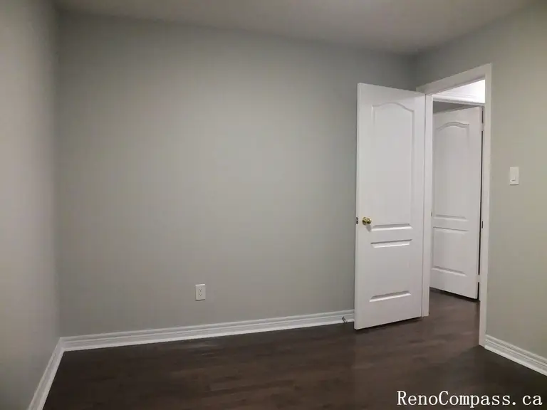 This Richmond Hill interior renovation showcases a refreshed bedroom with rich hardwood flooring, smooth neutral wall finishes, and updated trim details. Completed by a professional Toronto renovation company, the space is designed to feel bright, clean, and versatile for modern living. The refined finishes and cohesive color palette create a comfortable and timeless room suitable for everyday use or guest accommodation.
