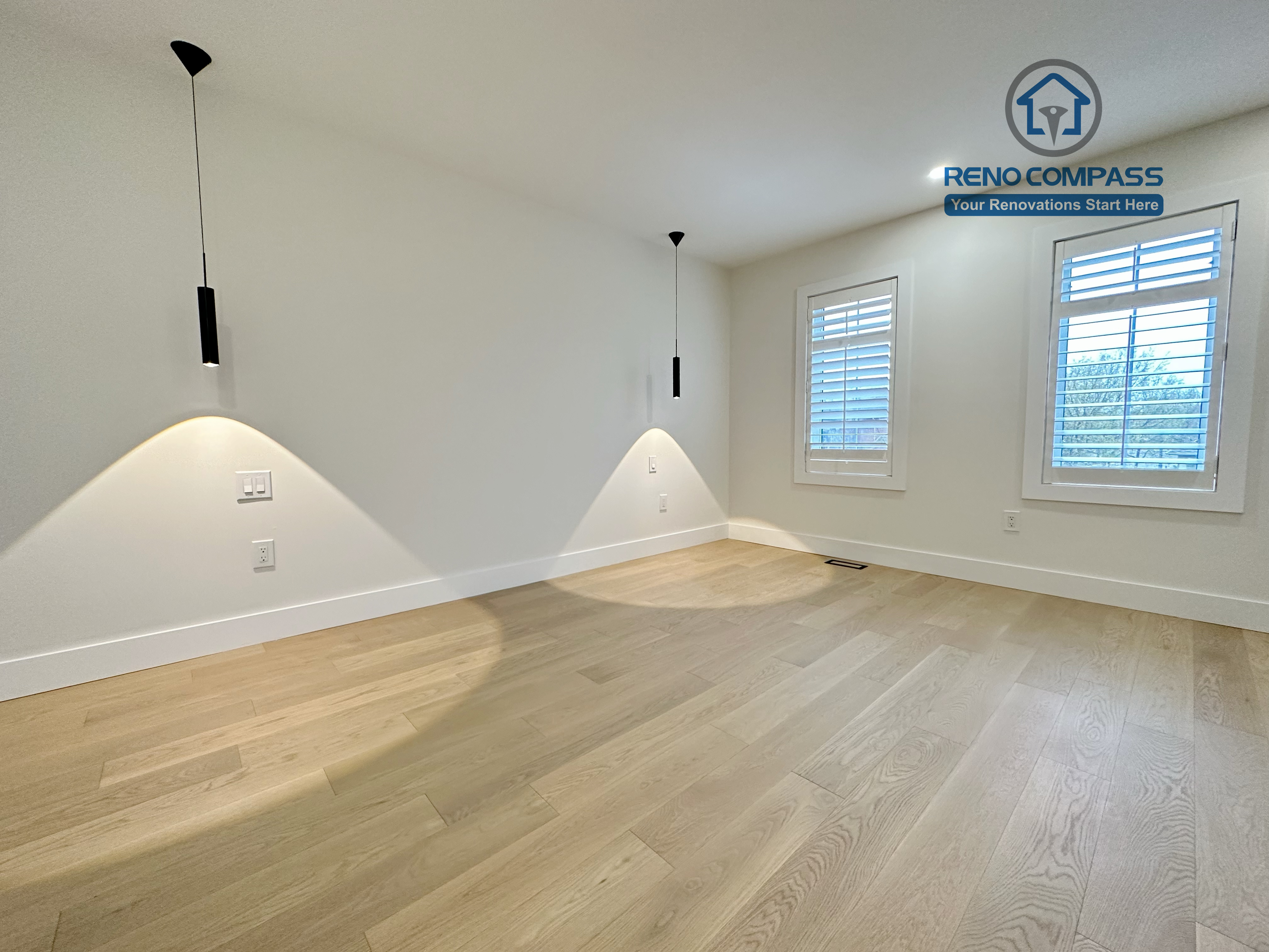 Modern bedroom renovation in a Richmond Hill home featuring light-tone hardwood flooring, minimalist pendant accent lighting, clean white walls, and a sleek, contemporary interior finish.