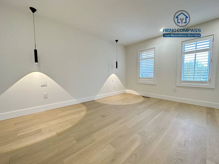 Modern bedroom renovation in a Richmond Hill home featuring light-tone hardwood flooring, minimalist pendant accent lighting, clean white walls, and a sleek, contemporary interior finish.