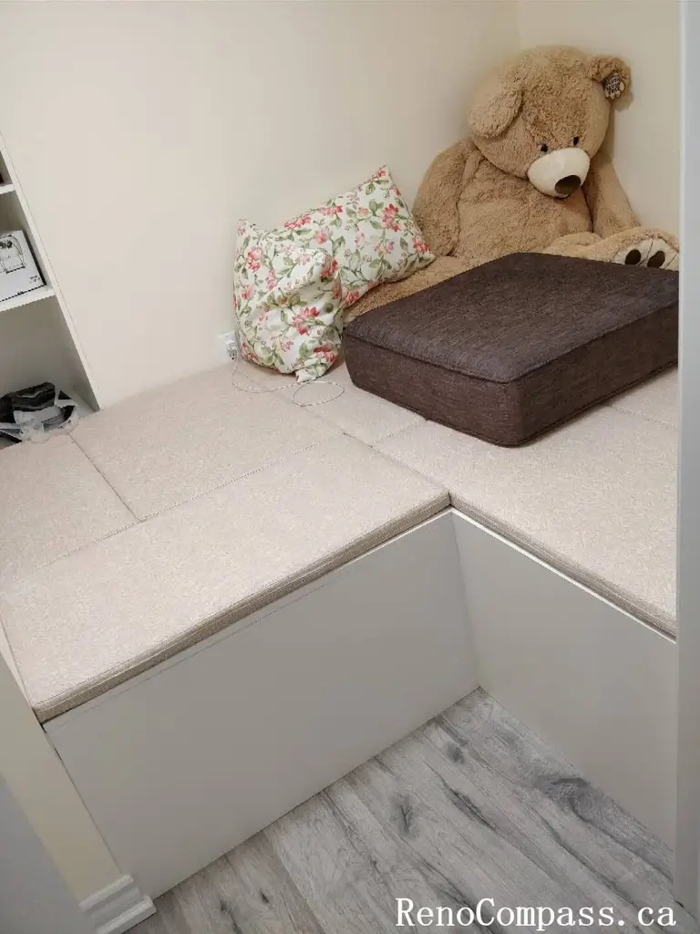 Full view of a custom-designed interior storage unit in Markham. This project includes integrated shaker-style base cabinets, open display shelving, and a modern clothing rod, all finished in a clean white aesthetic.