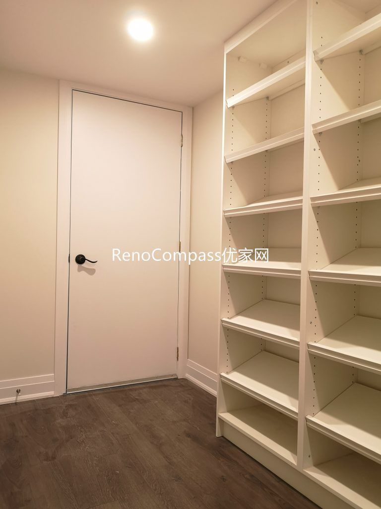 Newly finished Richmond Hill basement storage room featuring custom built-in shelving, durable wood flooring, and clean modern lighting. This basement renovation by Reno Compass Inc. improves organization, storage capacity, and everyday functionality for homeowners.