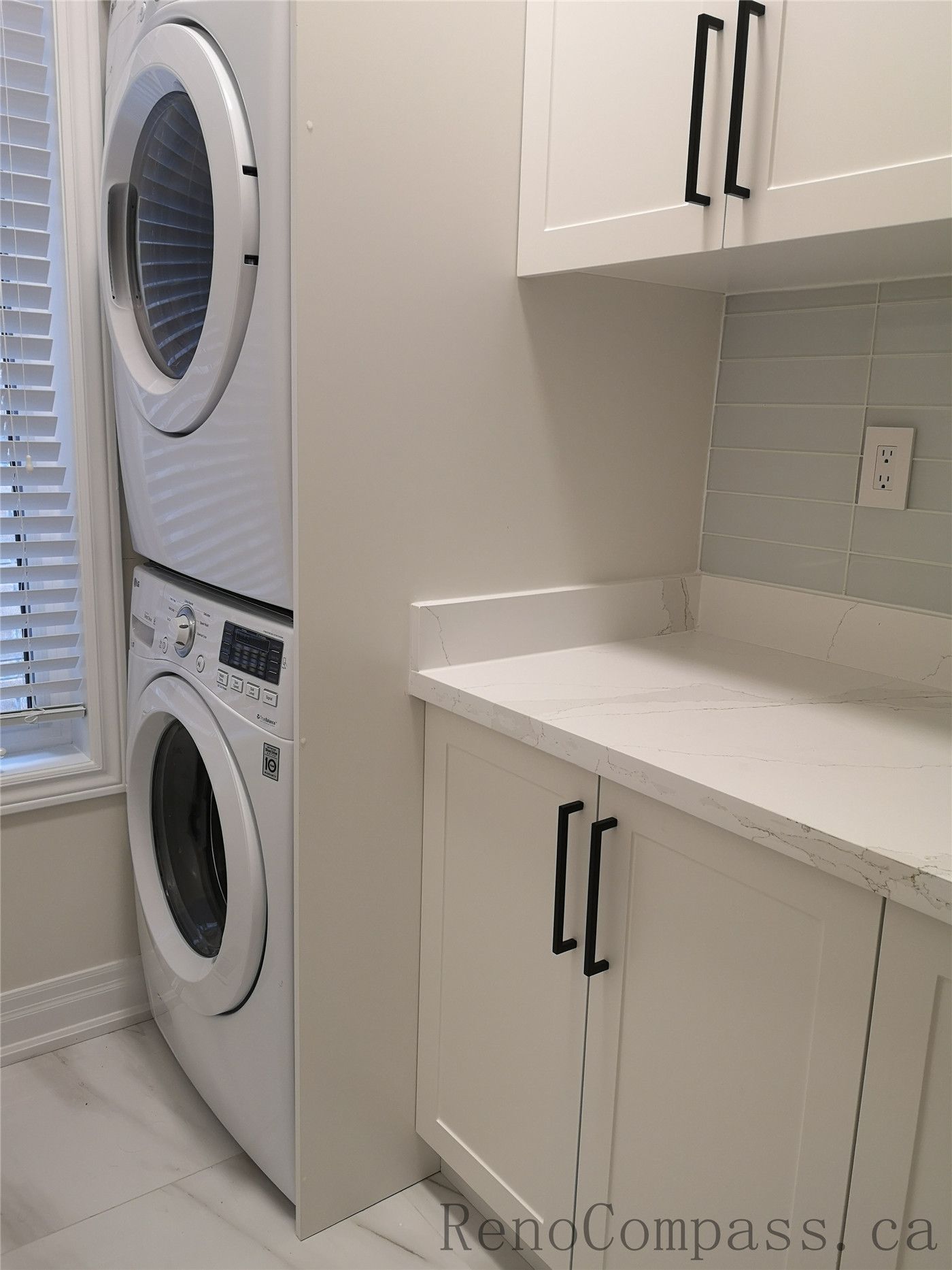 This Aurora interior renovation project features a modern laundry room upgrade with custom white cabinetry, quartz countertop, and stacked washer and dryer installation. Designed for functionality and clean aesthetics, the space maximizes storage and efficiency while maintaining a bright and contemporary look. Completed by a professional Toronto renovation team with attention to detail and quality craftsmanship.