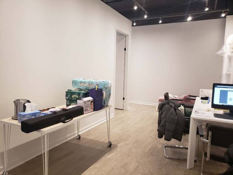This image highlights the reception and consultation area of a modern beauty and massage spa, completed by a professional Toronto renovation company specializing in commercial interior renovations. The space features clean wall finishes, wood-look flooring, and an open ceiling concept with track lighting to create a contemporary and welcoming environment. Functional workspace planning allows for efficient client check-in, consultation, and daily operations. The minimalist layout and neutral tones enhance the overall calm and professional atmosphere, making it ideal for spa, wellness, and beauty clinic interiors across Toronto and the GTA.