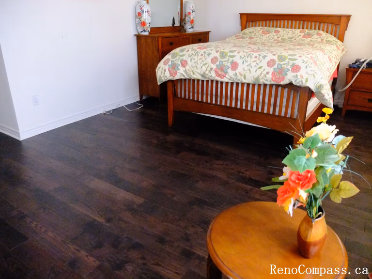 Toronto home hardwood flooring installation featuring deep-toned wood floors throughout the hallway and upper level. This professional flooring renovation enhances brightness, durability, and visual continuity, completed by Reno Compass for a clean and modern interior upgrade.