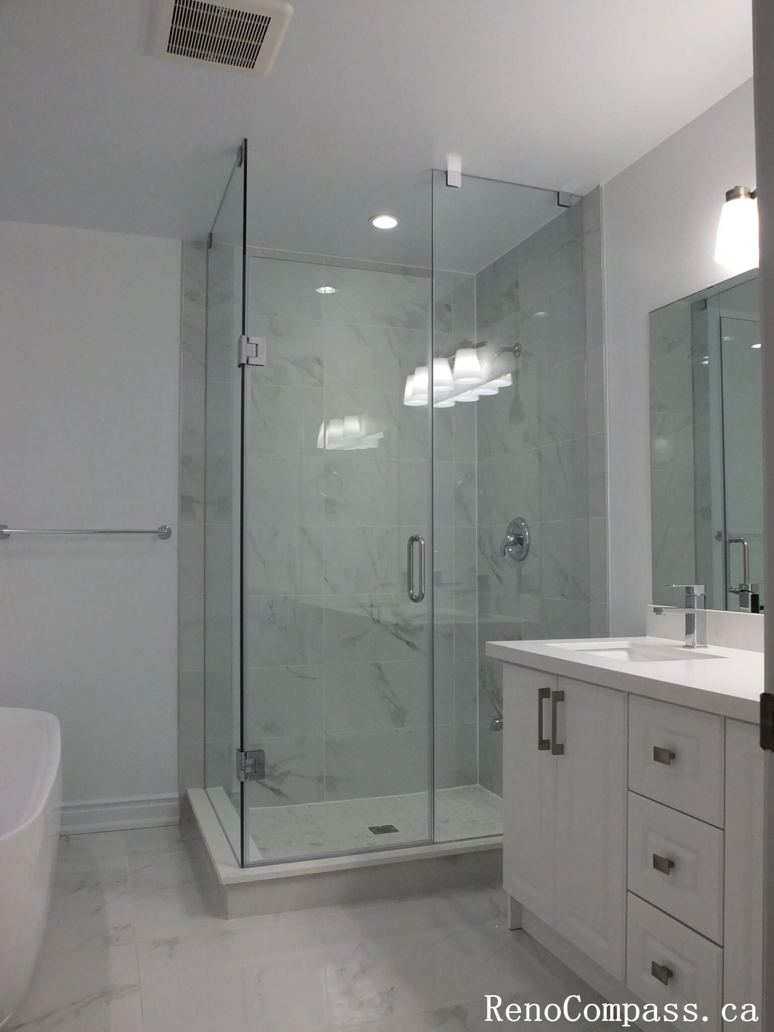 This Richmond Hill bathroom renovation features a sleek glass-enclosed shower, marble-look wall tiles, and a modern white vanity with quartz countertop. Completed by a professional Toronto renovation company, the space was redesigned to enhance brightness, functionality, and everyday comfort. Clean lines, neutral tones, and contemporary fixtures create a fresh, elegant bathroom environment built for long-term durability and style.