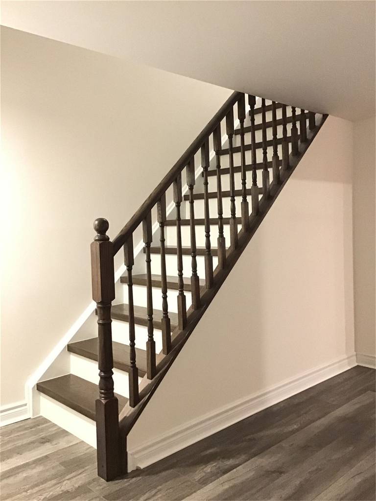 This Richmond Hill basement renovation includes an upgraded staircase featuring dark wood treads paired with clean white risers for a modern contrast look. The sturdy handrail and refined finish enhance both safety and aesthetics, making the transition between floors more stylish and functional. A great example of basement stair renovation in Richmond Hill.