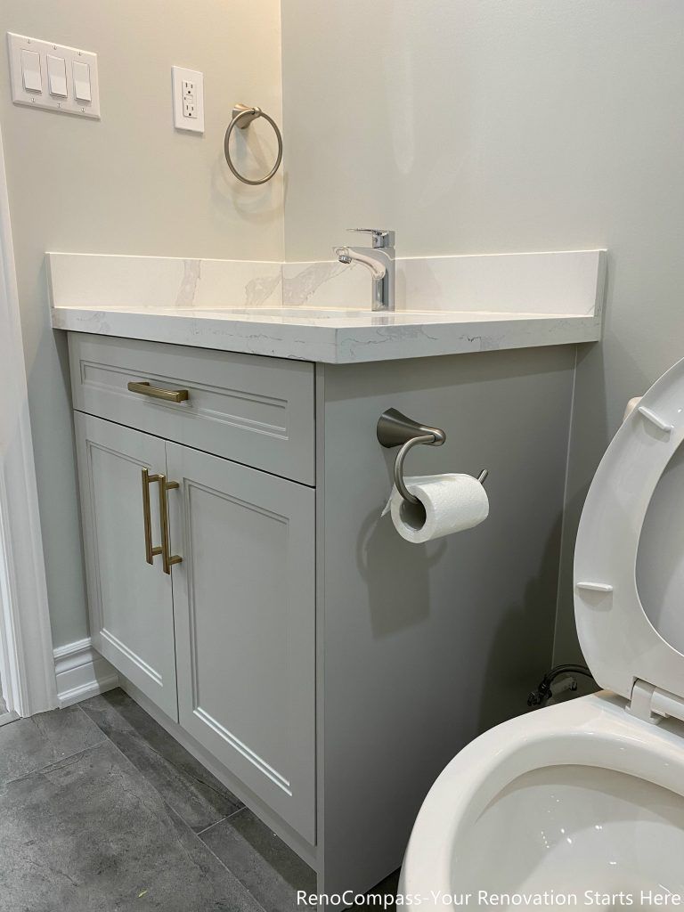 This Oakville basement renovation features a modern bathroom vanity with a quartz countertop, contemporary cabinetry, and upgraded fixtures designed for durability and functionality. The compact layout maximizes storage while maintaining a clean and modern aesthetic, paired with durable floor tiles and quality finishes. Completed by a professional Toronto renovation company, this basement bathroom upgrade enhances everyday convenience, improves usability, and adds long-term value to the finished lower-level living space.