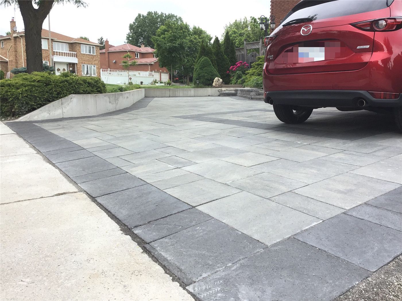 A complete front yard landscaping renovation in Mississauga featuring a modern interlocking driveway, clean border detailing, and a spacious parking layout. This project enhances curb appeal, improves functionality, and delivers a durable, low-maintenance outdoor surface designed for long-term use.