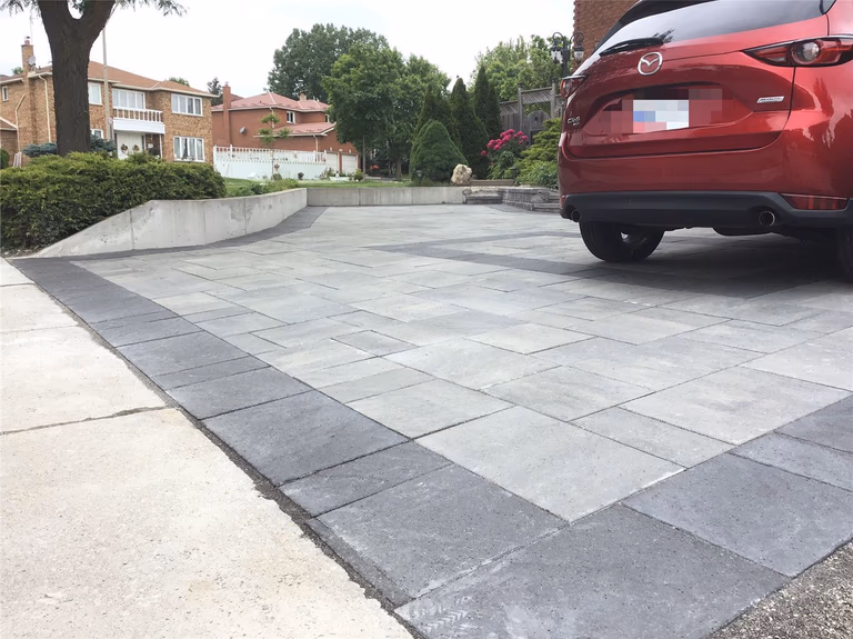 A complete front yard landscaping renovation in Mississauga featuring a modern interlocking driveway, clean border detailing, and a spacious parking layout. This project enhances curb appeal, improves functionality, and delivers a durable, low-maintenance outdoor surface designed for long-term use.