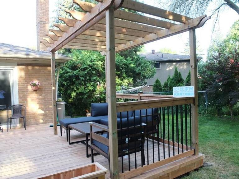 This Vaughan backyard deck project showcases a custom-built pressure-treated wood platform paired with a handcrafted pergola structure. The open-beam pergola design provides partial shade while maintaining airflow and natural light, creating a comfortable outdoor lounge environment.

The deck features black aluminum railings for safety and a modern contrast against the natural wood finish. With a spacious seating area and seamless transition from the home’s rear entrance, this deck enhances both functionality and visual appeal. Professionally constructed for durability, this outdoor upgrade significantly improves backyard usability and property value.