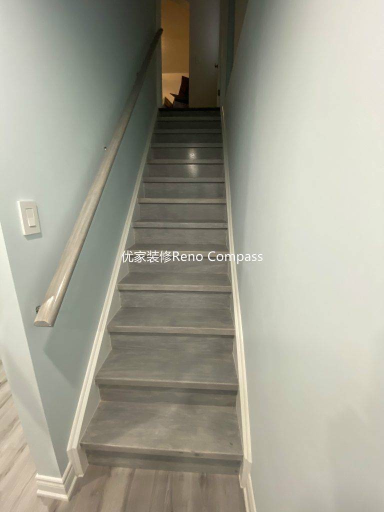 This Aurora basement renovation includes a newly upgraded staircase completed by a professional Toronto renovation company. The stairs feature durable modern vinyl step finishes, updated white trim, and a secure contemporary handrail for safety and style. Clean lines and coordinated flooring seamlessly connect the basement to the upper level, creating a cohesive and polished transition that enhances both functionality and overall home value. Contractor: Reno Compass Inc.