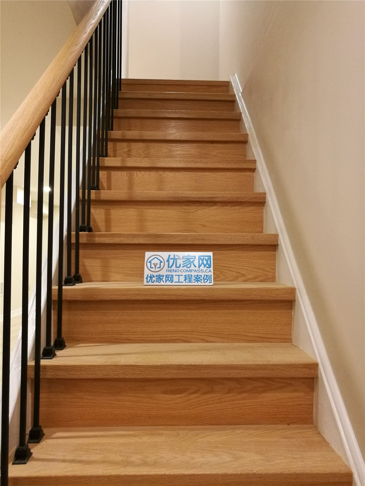 Basement staircase renovation in Markham featuring solid wood stair treads, modern black metal railings, and clean neutral wall finishes. This upgrade enhances safety, durability, and visual appeal, creating a seamless transition between levels. Completed by a reliable Toronto renovation company serving Markham and the GTA.