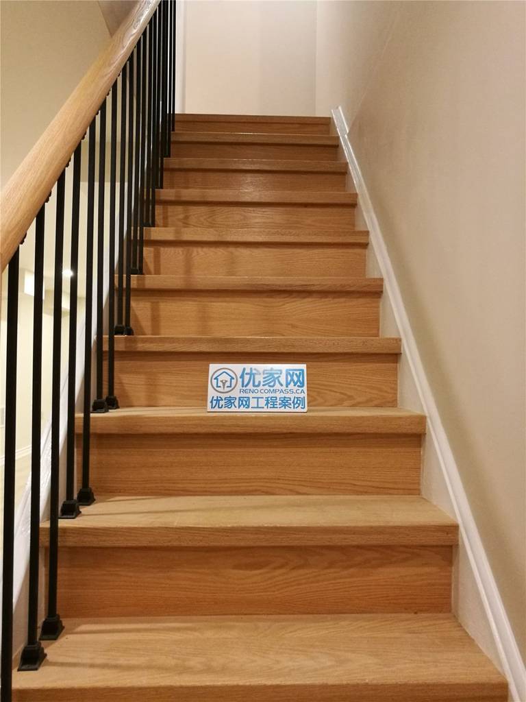 Basement staircase renovation in Markham featuring solid wood stair treads, modern black metal railings, and clean neutral wall finishes. This upgrade enhances safety, durability, and visual appeal, creating a seamless transition between levels. Completed by a reliable Toronto renovation company serving Markham and the GTA.