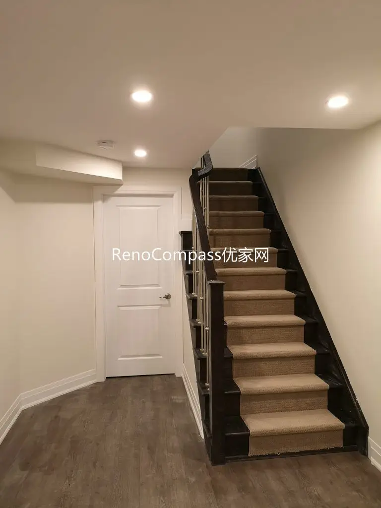 Finished Richmond Hill basement staircase renovation featuring upgraded wood stairs, modern railing, pot lights, and durable flooring. Completed by Reno Compass Inc., this basement upgrade improves safety, brightness, and overall home functionality.