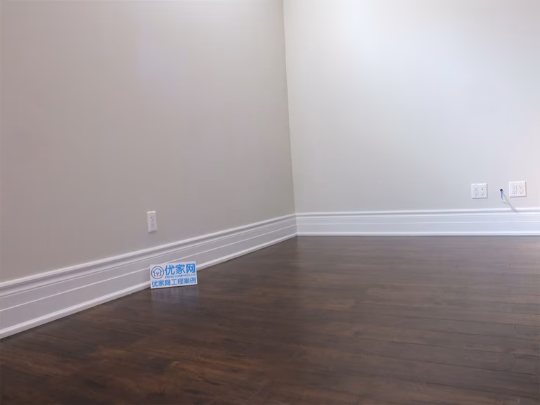This Richmond Hill basement renovation features a spacious open-concept living area with dark hardwood flooring, recessed lighting, and bright basement windows. The natural light reflecting off the flooring enhances the sense of space, creating a warm and inviting environment ideal for family use or entertainment.