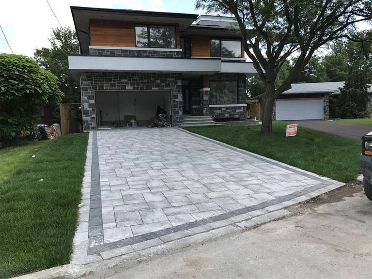 This Markham landscaping renovation features a professionally installed interlocking stone driveway that enhances curb appeal and durability. The project includes precision-laid paving stones, clean edge borders, and a smooth driveway surface designed to complement the modern home exterior. Completed by a trusted Toronto Renovation Company, this landscaping upgrade provides both long-lasting performance and an elegant outdoor aesthetic.